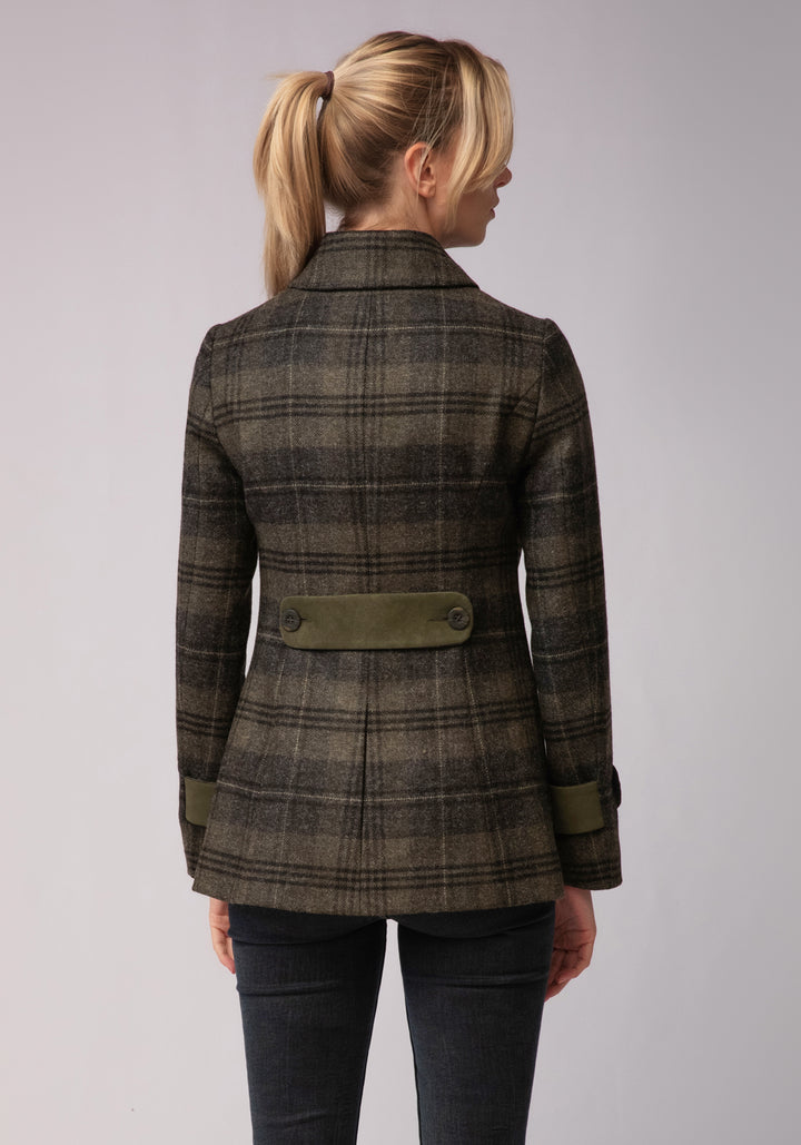 Back of woman wearing grey and green check wool jacket with moss green cuff and back belt detail