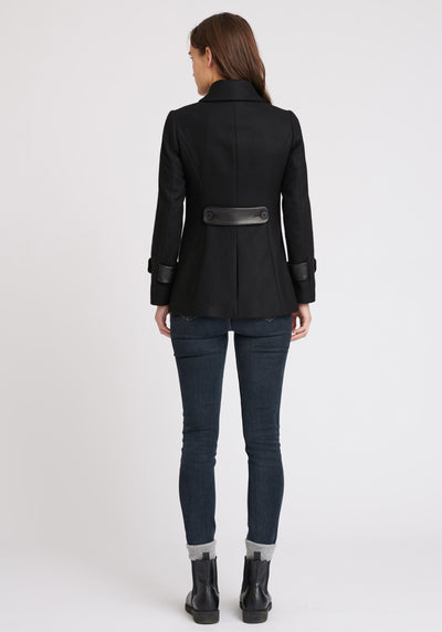 A model wears the Hendre jacket in black, a structured, slim-fit design with high collar and suede trim.