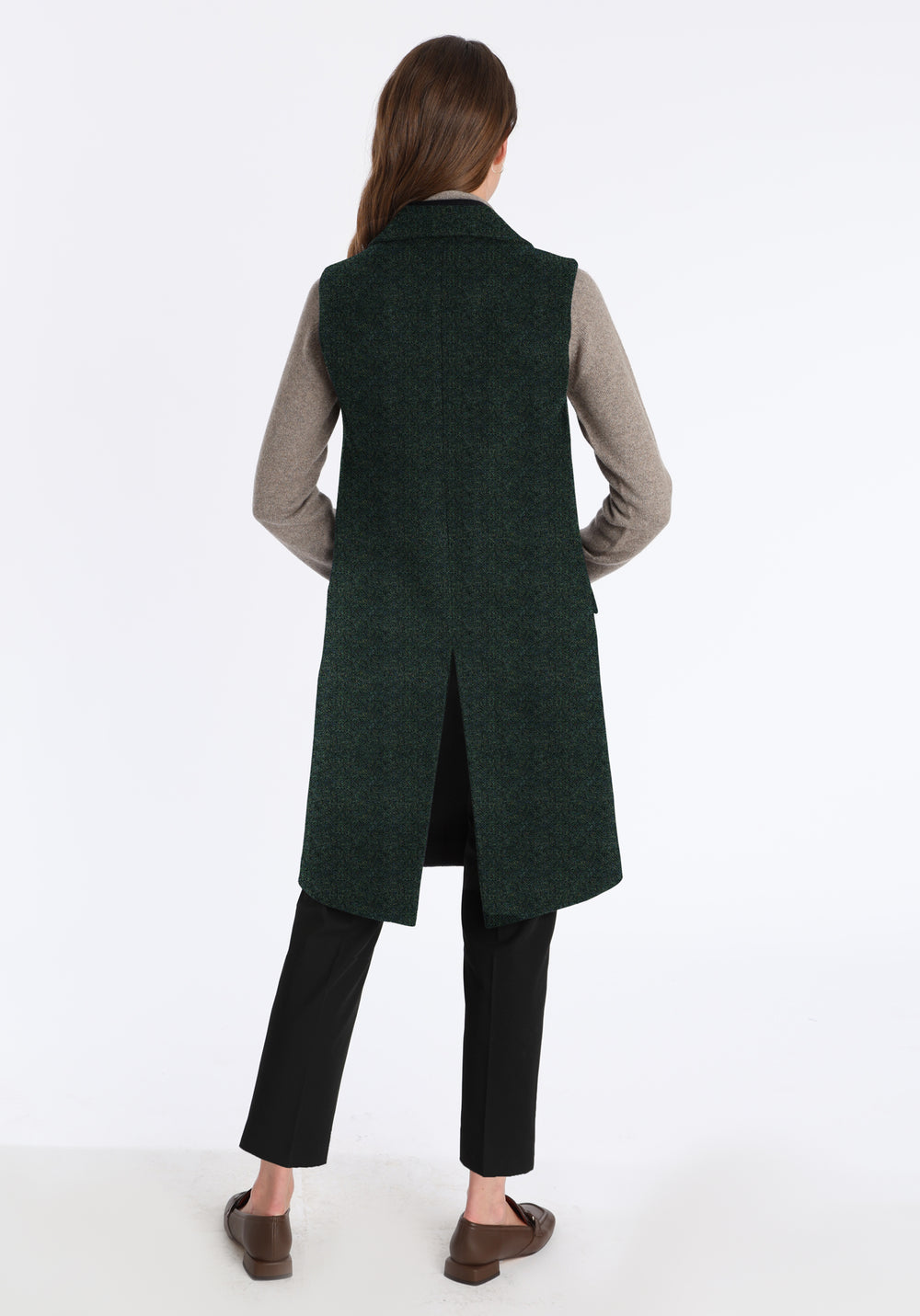 Back of woman wearing long dark green waistcoat