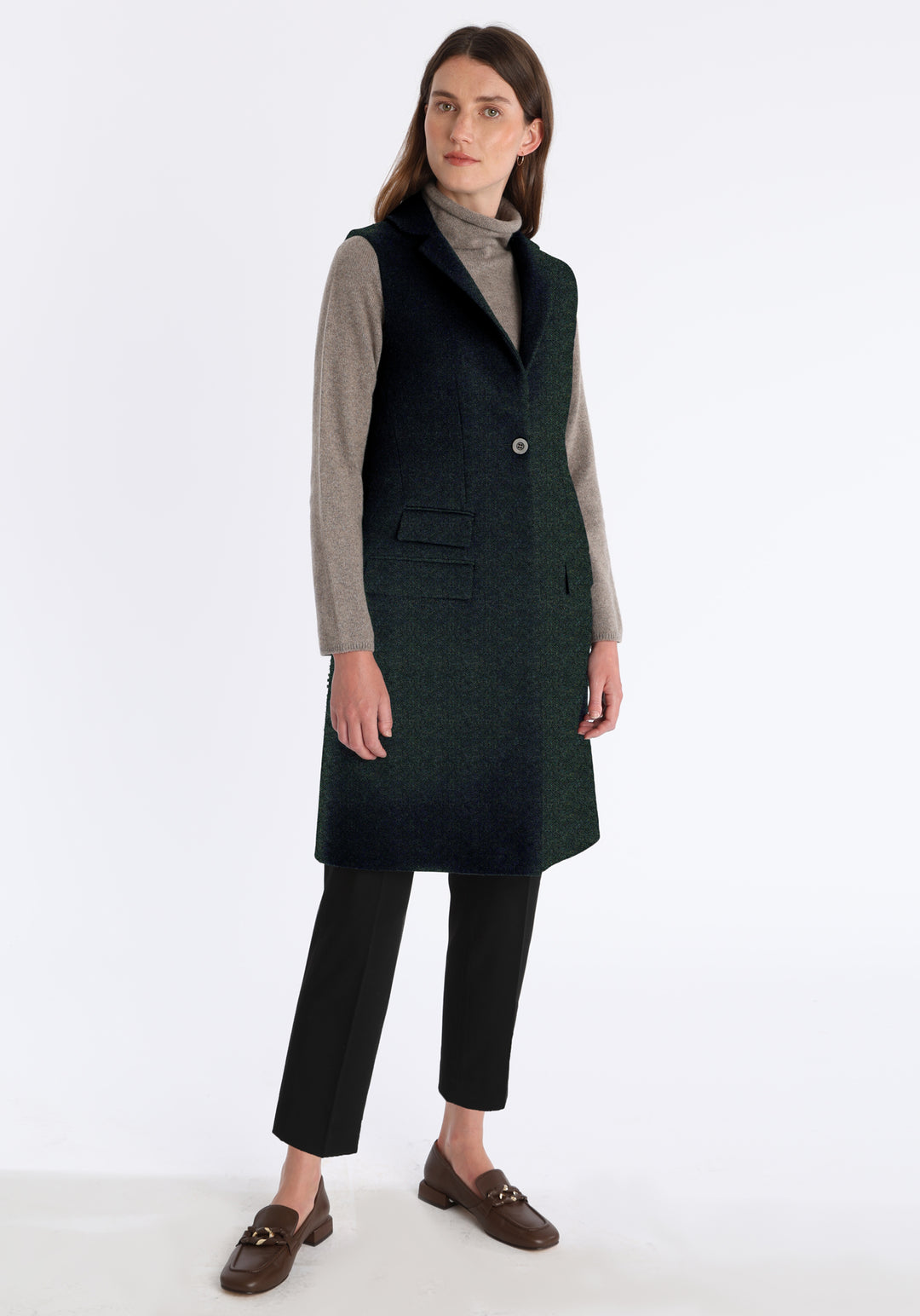 Woman wearing a dark green waistcoat with a single button