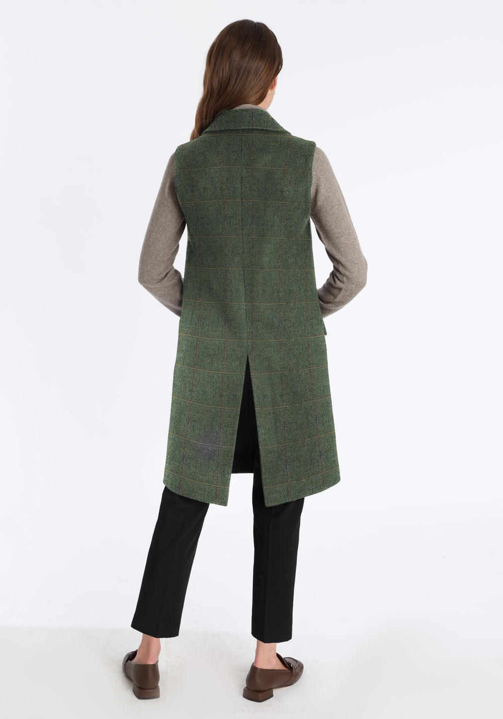 Back of woman wearing sage green long waistcoat