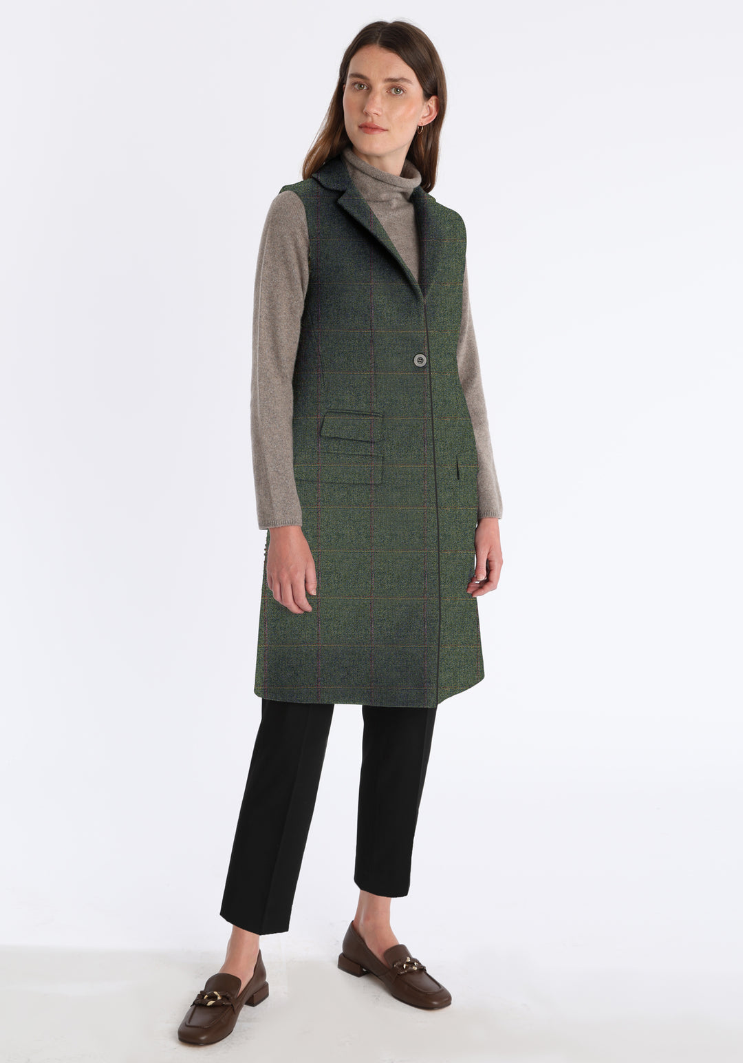 Woman wearing a sage green waistcoat with a single button