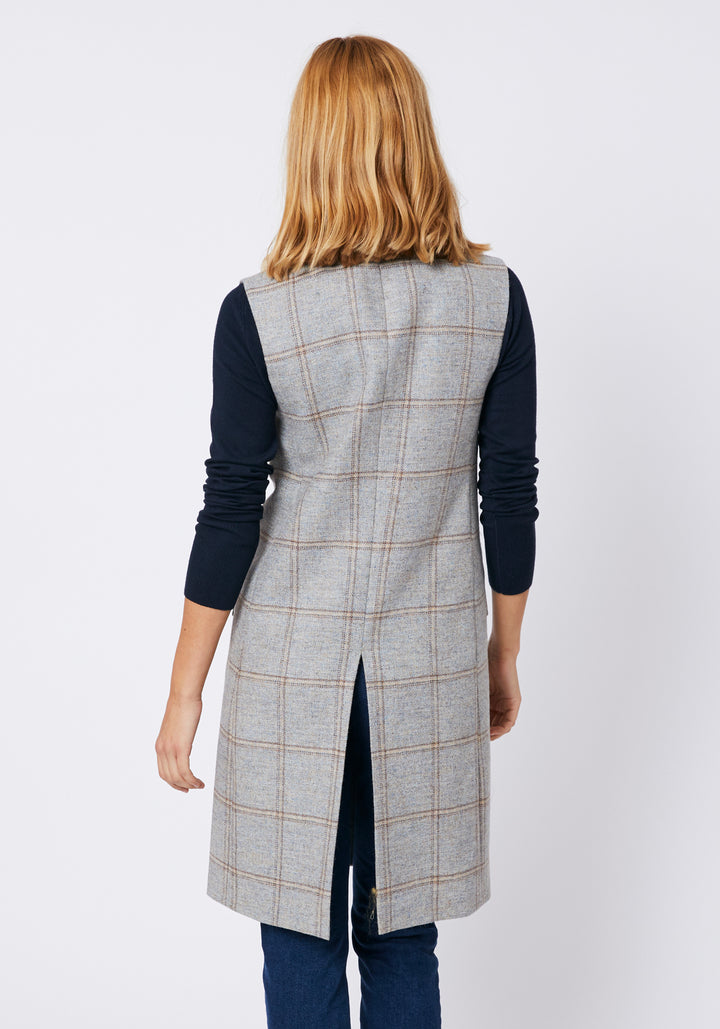 Back of woman wearing a blue grey check waistcoat
