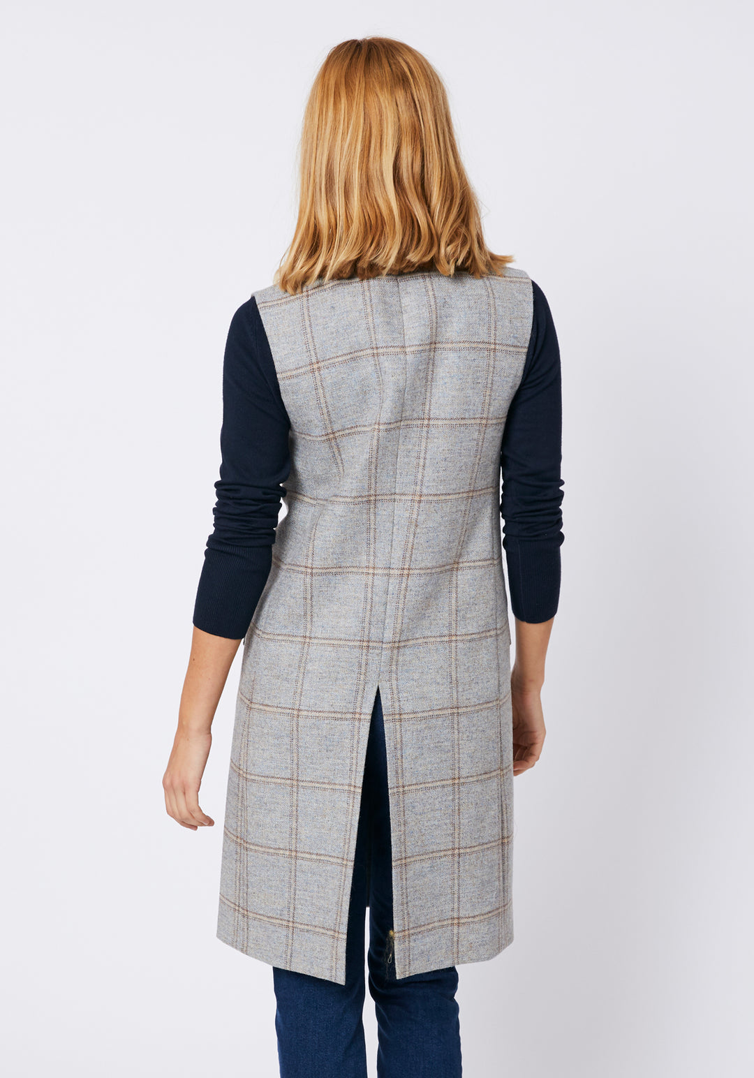 Back of woman wearing a blue grey check waistcoat