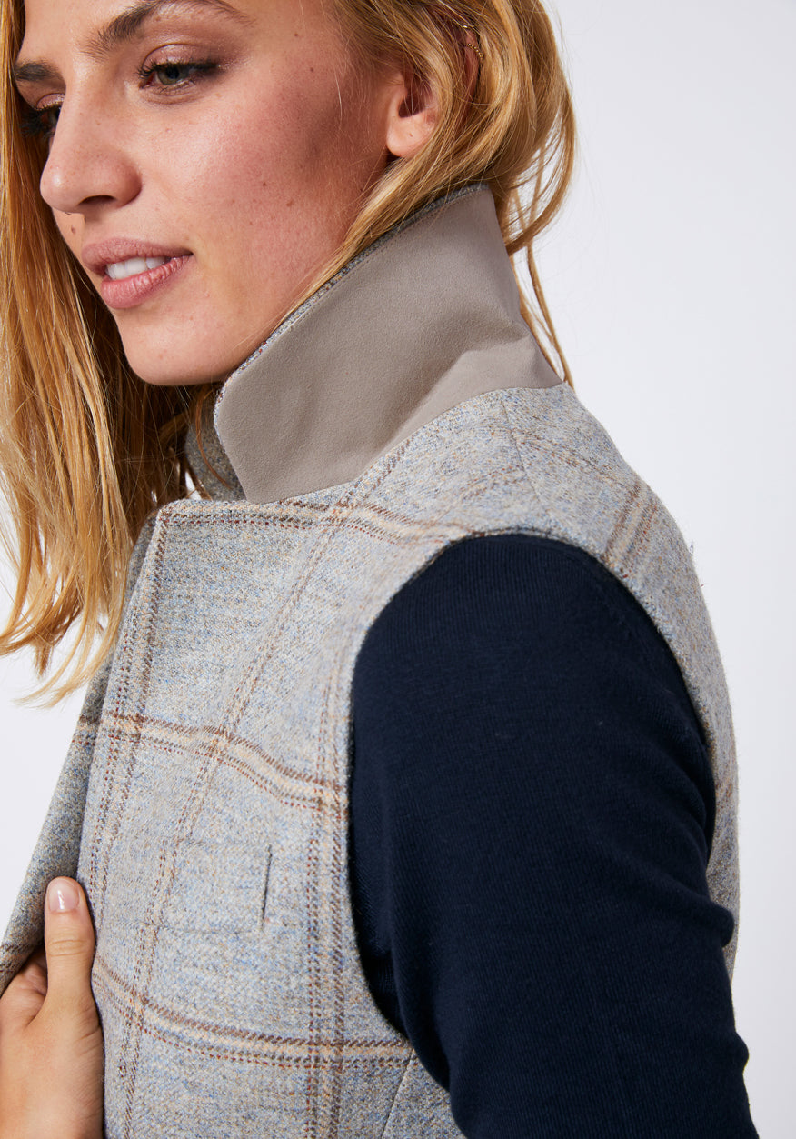 Close up of waistcoat with a cream color under the collar