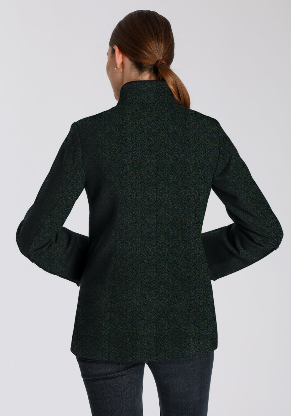 Back of a woman wearing a dark green jacket 