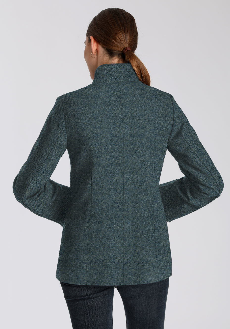 Back of a woman wearing a teal wool jacket