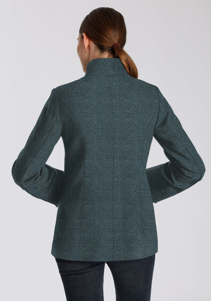Back of a woman wearing a teal wool jacket