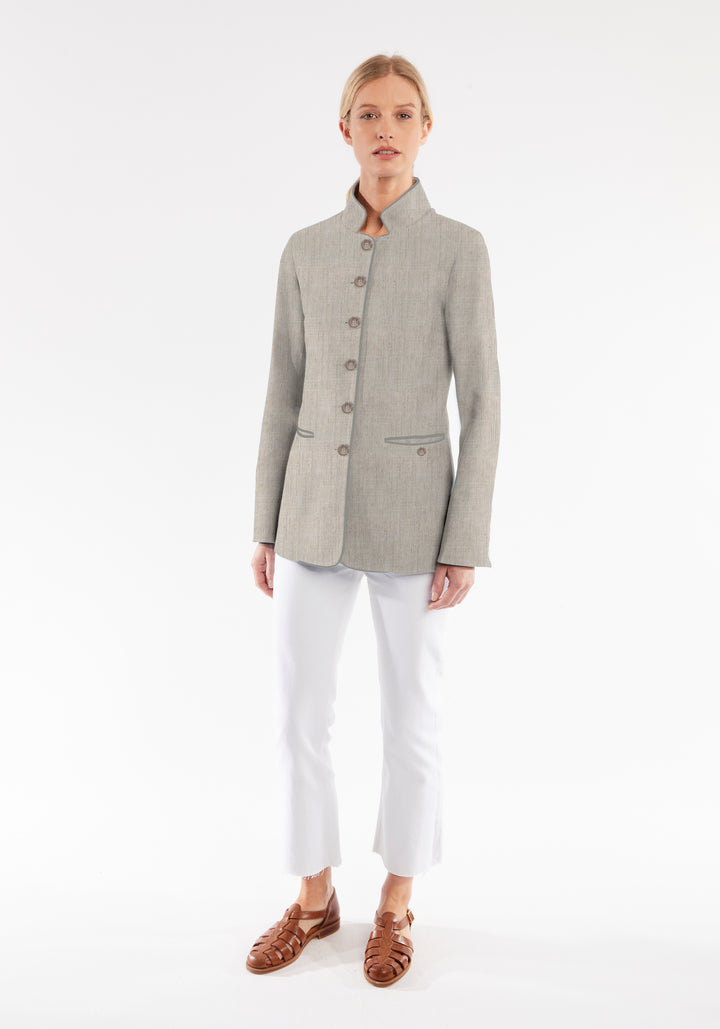 Model wearing the Patmos jacket in Chinchilla linen blend, a slim-fit style featuring a mandarin collar, front pockets, and generous sleeves with button detailing.