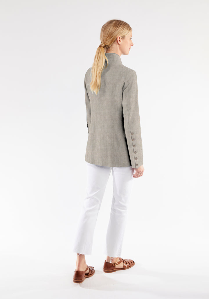 Model wearing the Patmos jacket in Chinchilla linen blend, a slim-fit style featuring a mandarin collar, front pockets, and generous sleeves with button detailing.