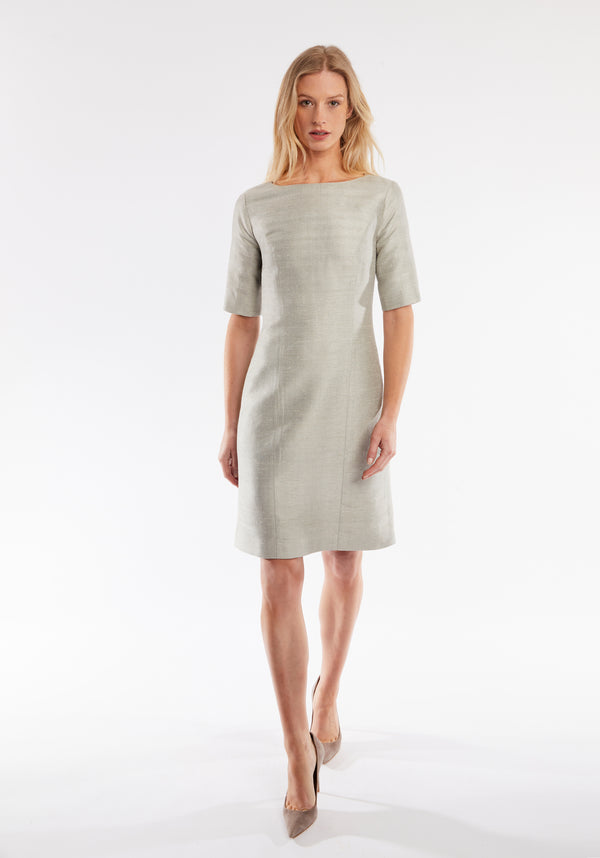 Woman wearing a light gray dress on a white background