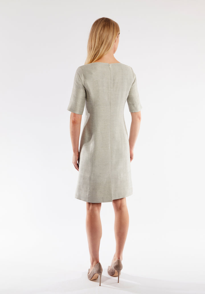 Woman wearing a light grey dress on a white background