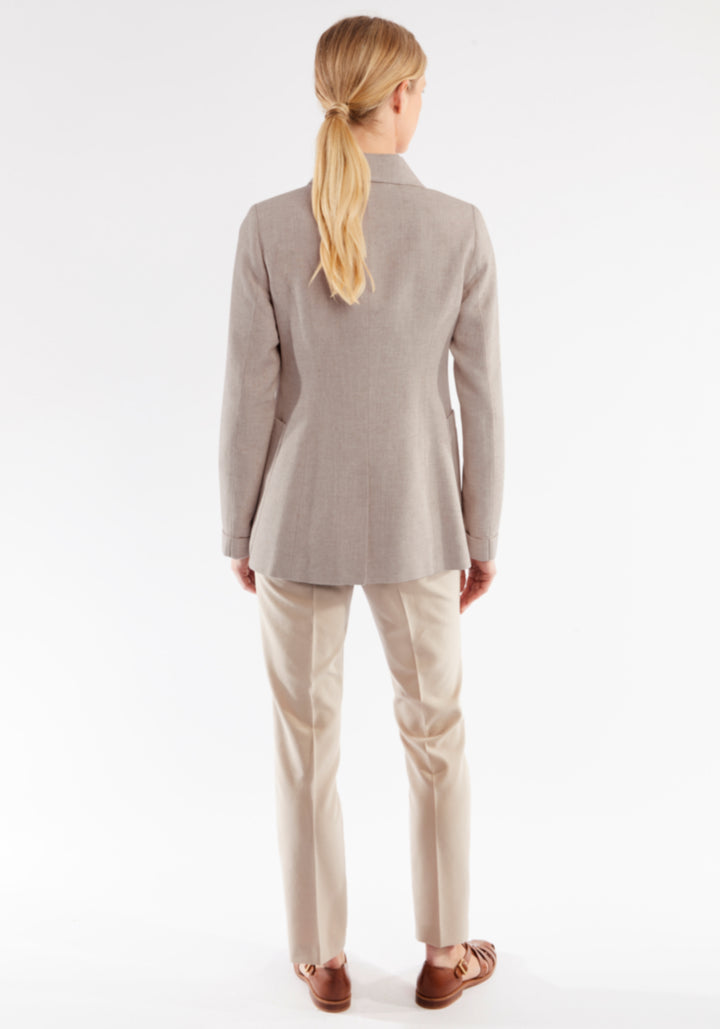 Woman wearing a pink jacket and pants on a white background