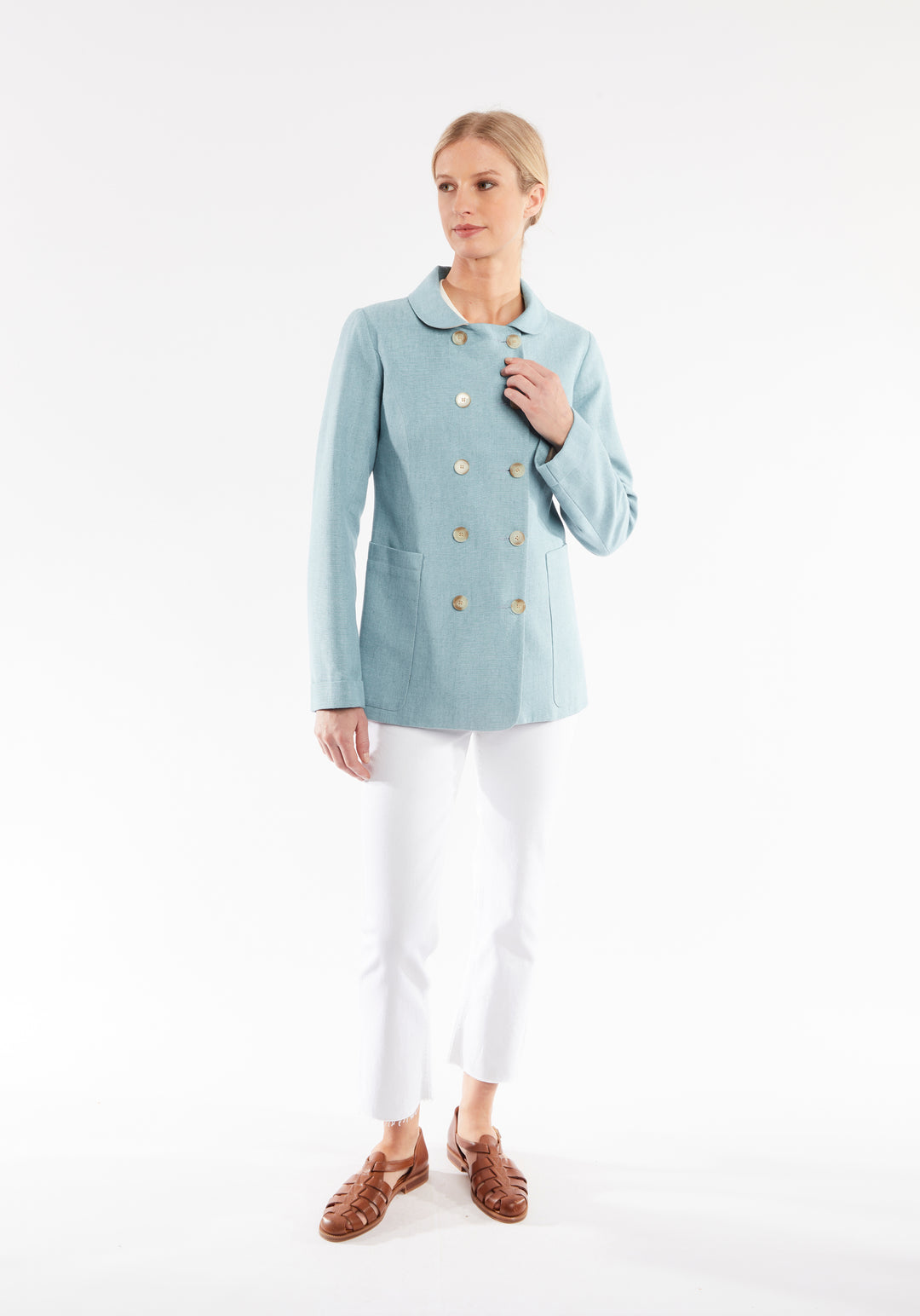 Woman wearing light blue jacket with double breasted buttons 