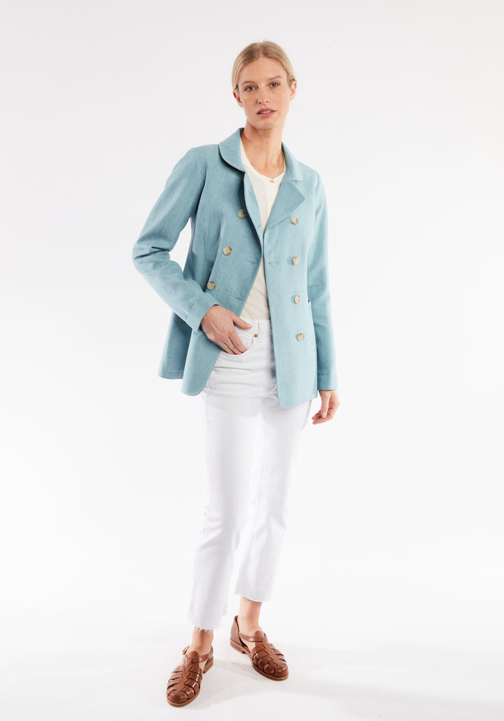 Woman wearing light blue jacket with double breasted buttons 
