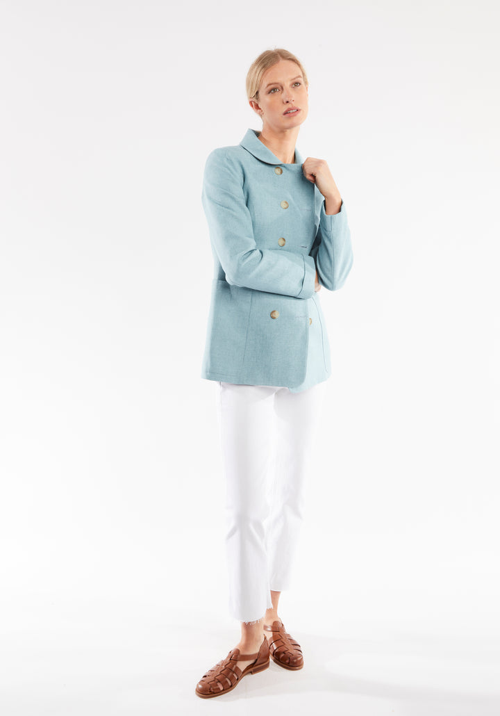 Woman wearing light blue jacket with double breasted buttons 