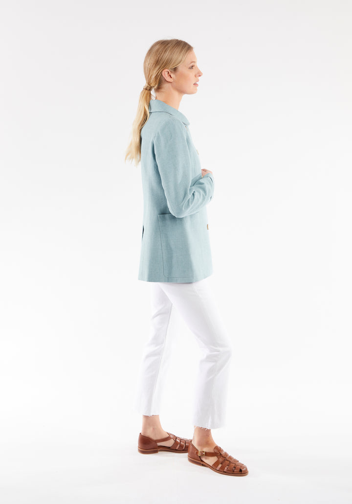 Side of woman wearing light blue jacket 