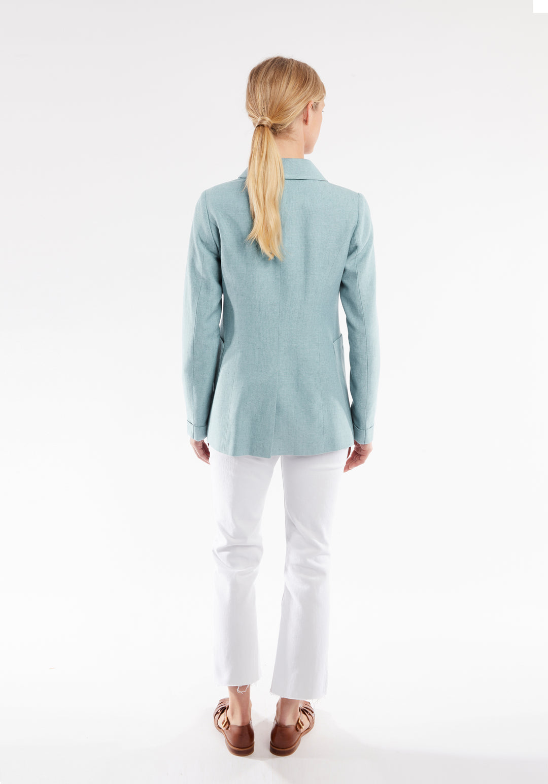 Back of woman wearing light blue jacket 