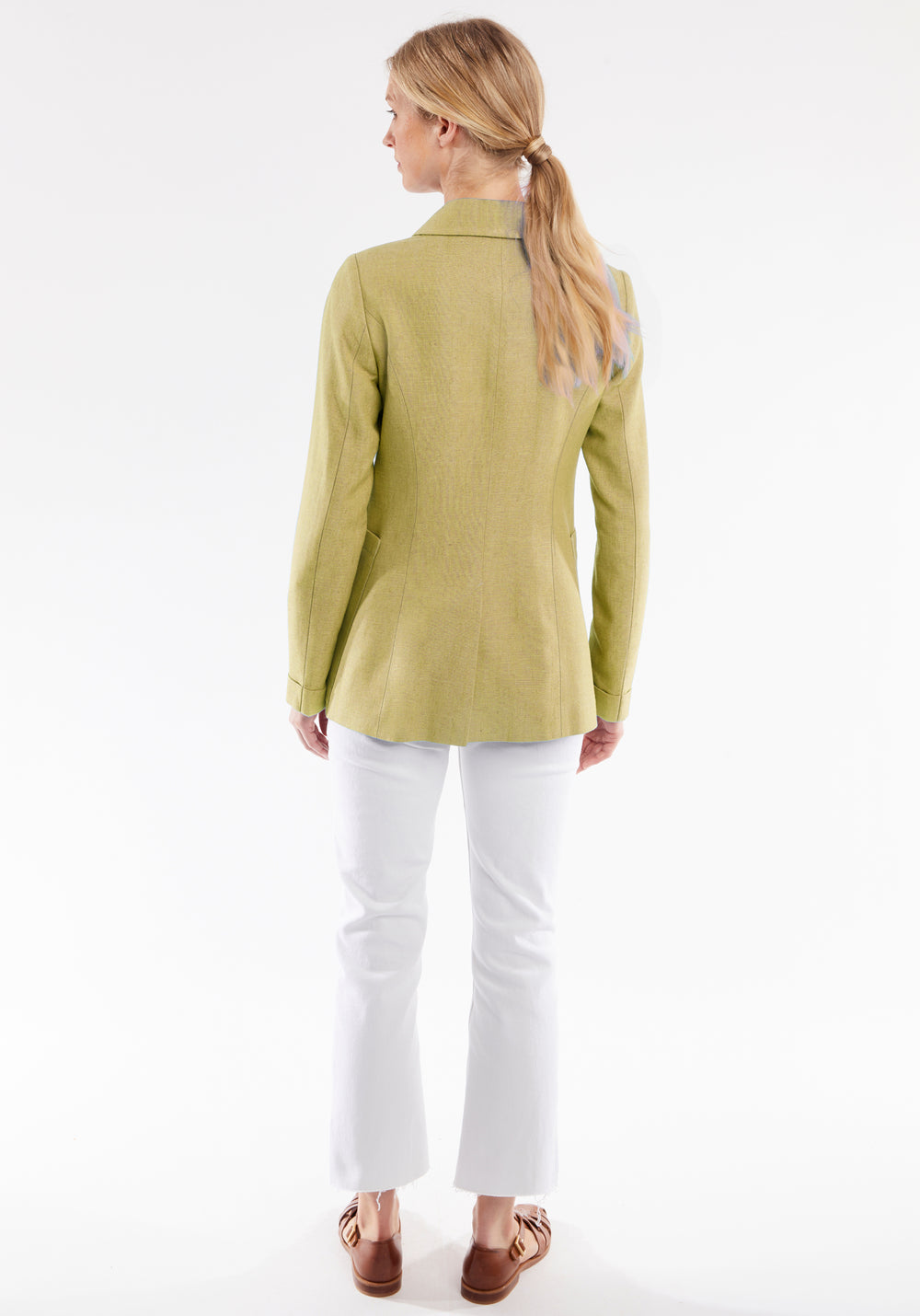 Woman wearing a light green jacket on a white background
