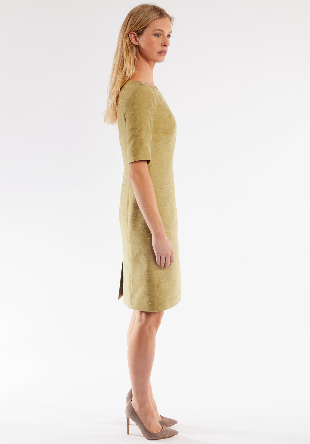 Woman wearing a cactus colored dress on a white background