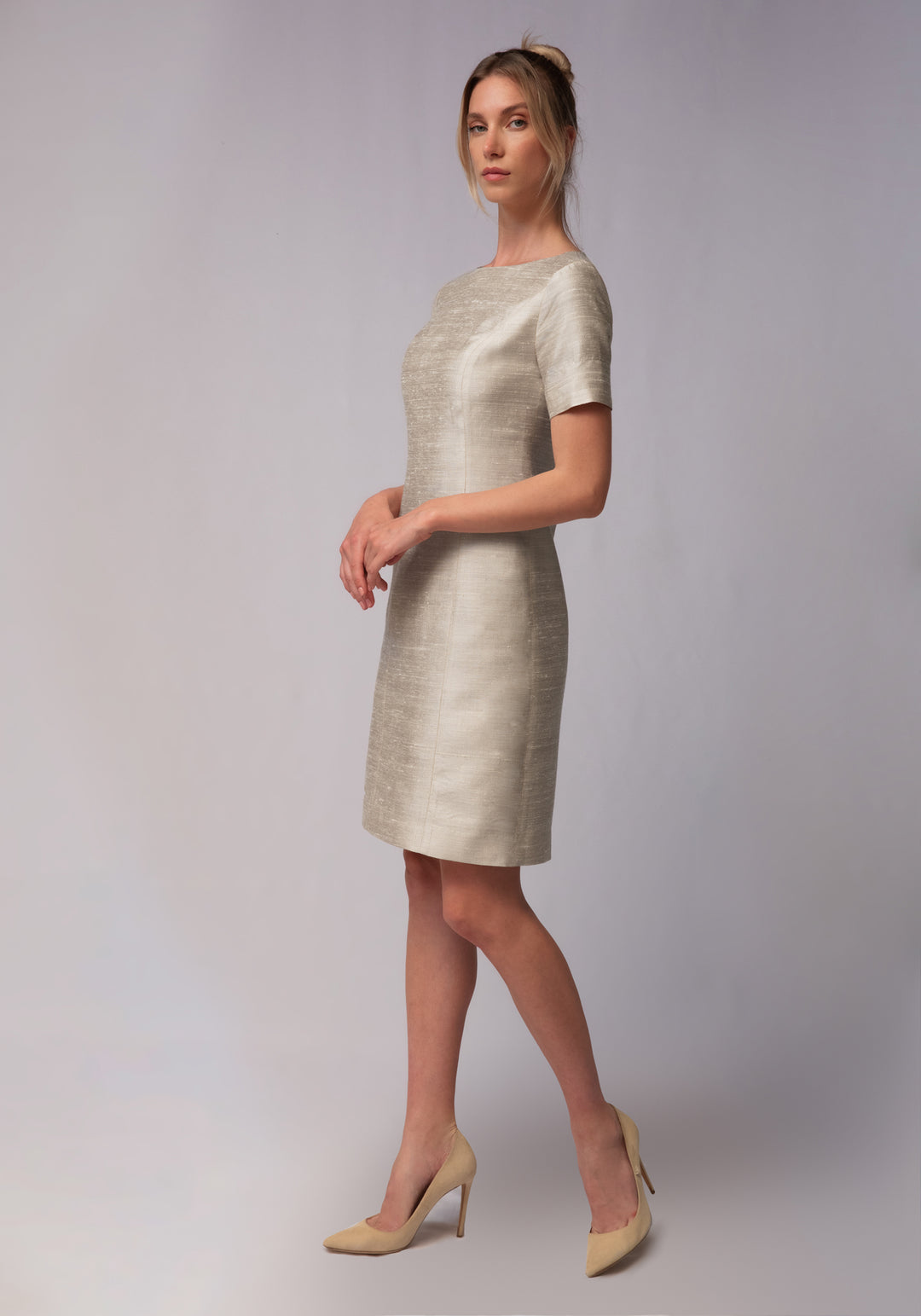 Woman wearing a light white dress against a white background