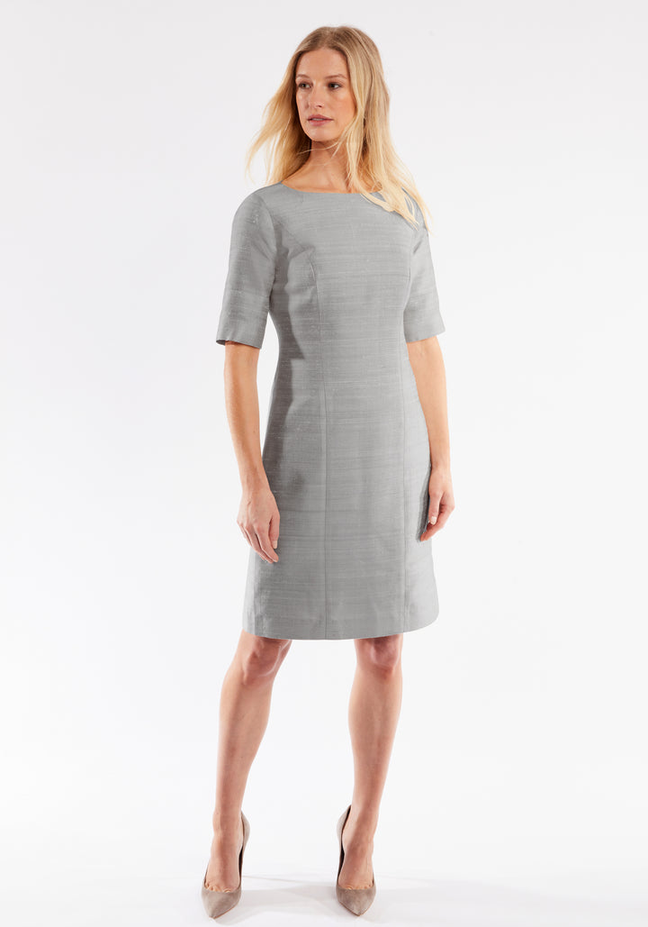Woman wearing a gray dress on a white background