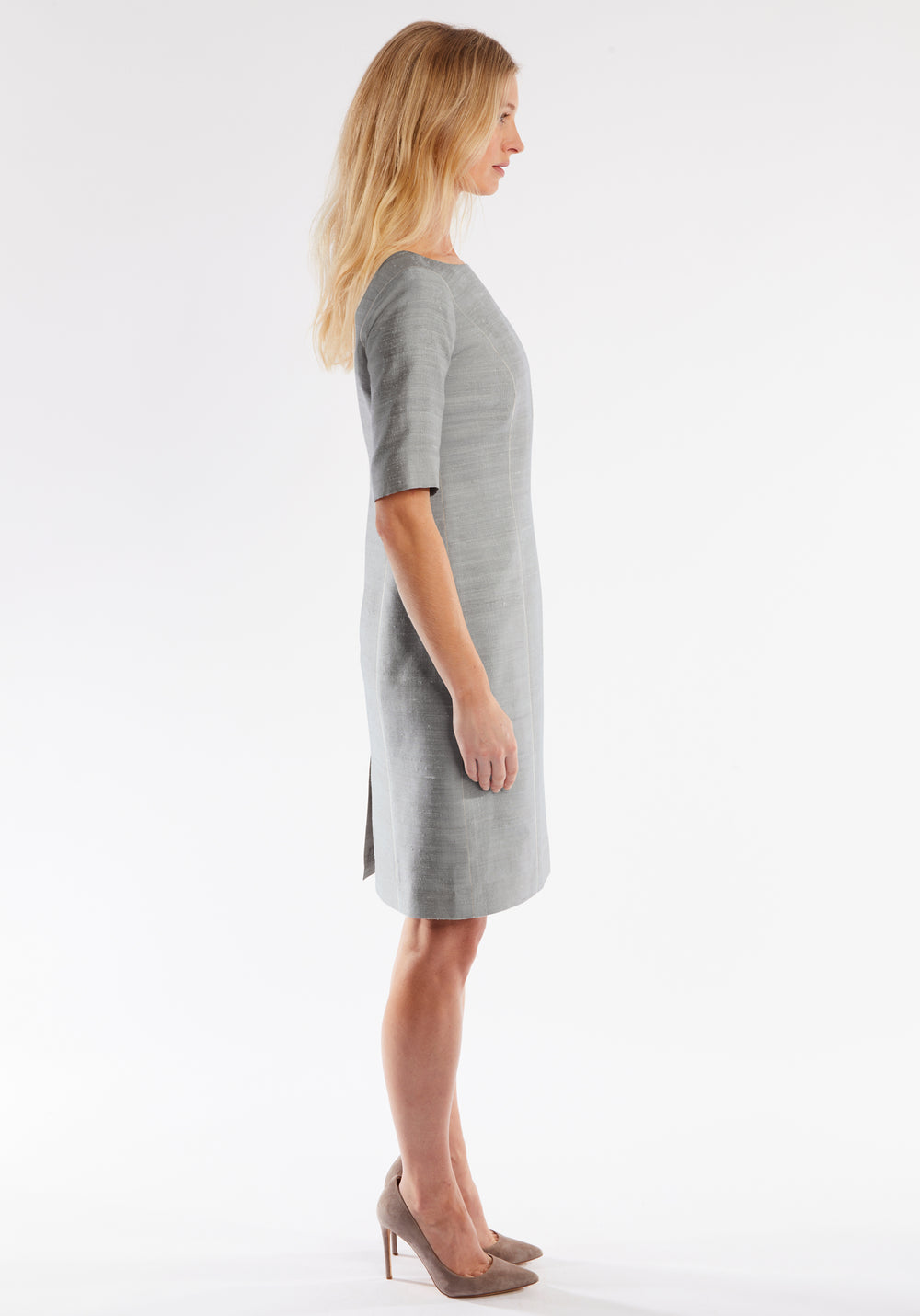 Woman wearing a gray dress on a white background