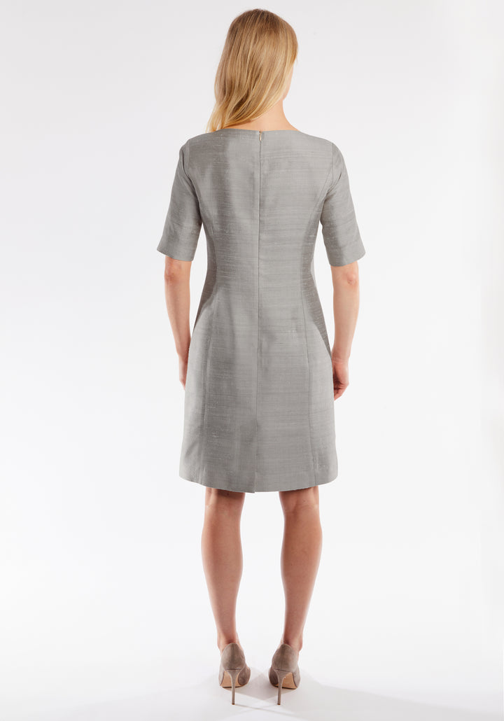 Woman wearing a gray dress on a white background