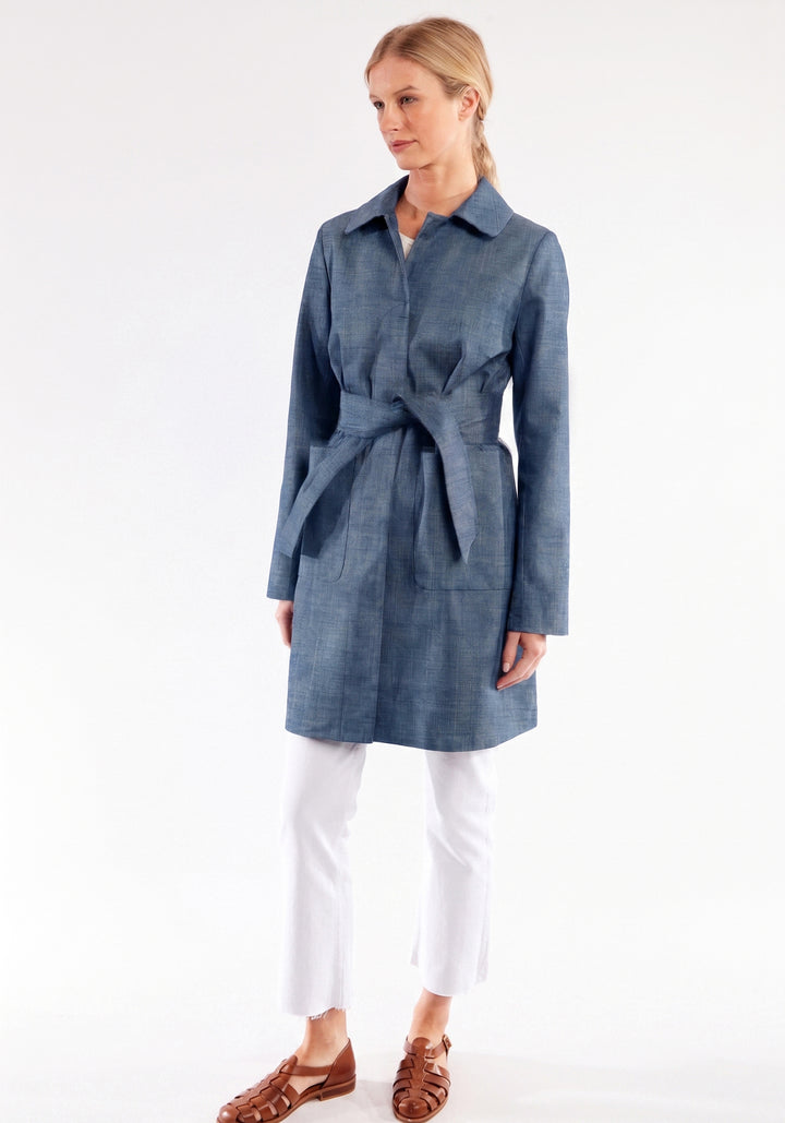Woman wearing a blue coat with a white background