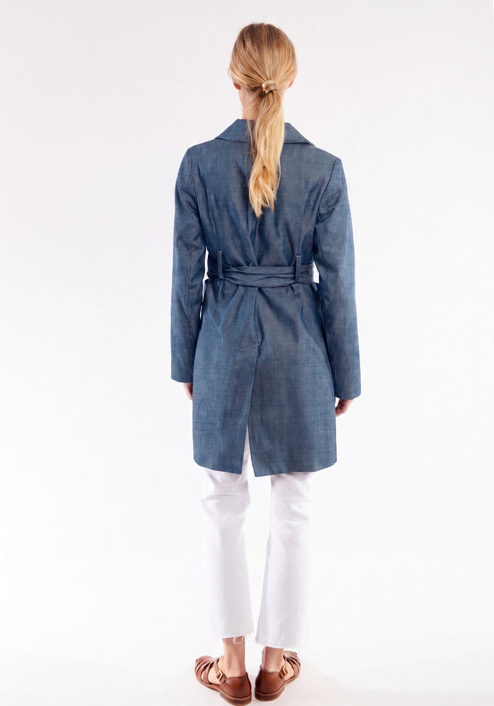 Woman wearing a blue coat with a white background