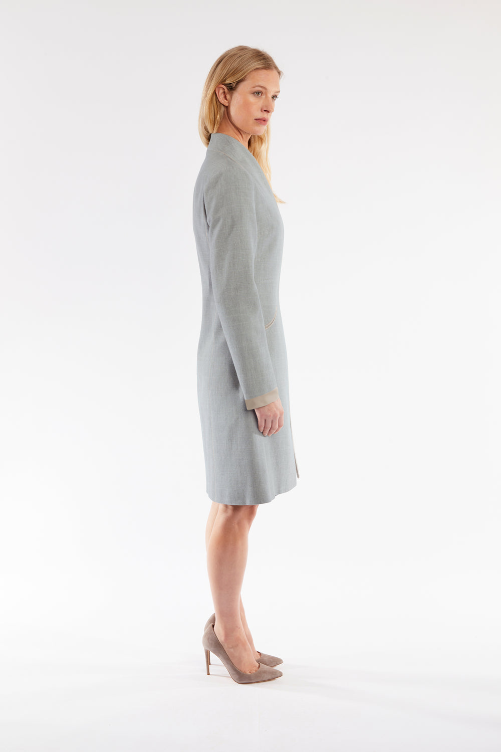 Woman wearing a gray coat on a white background