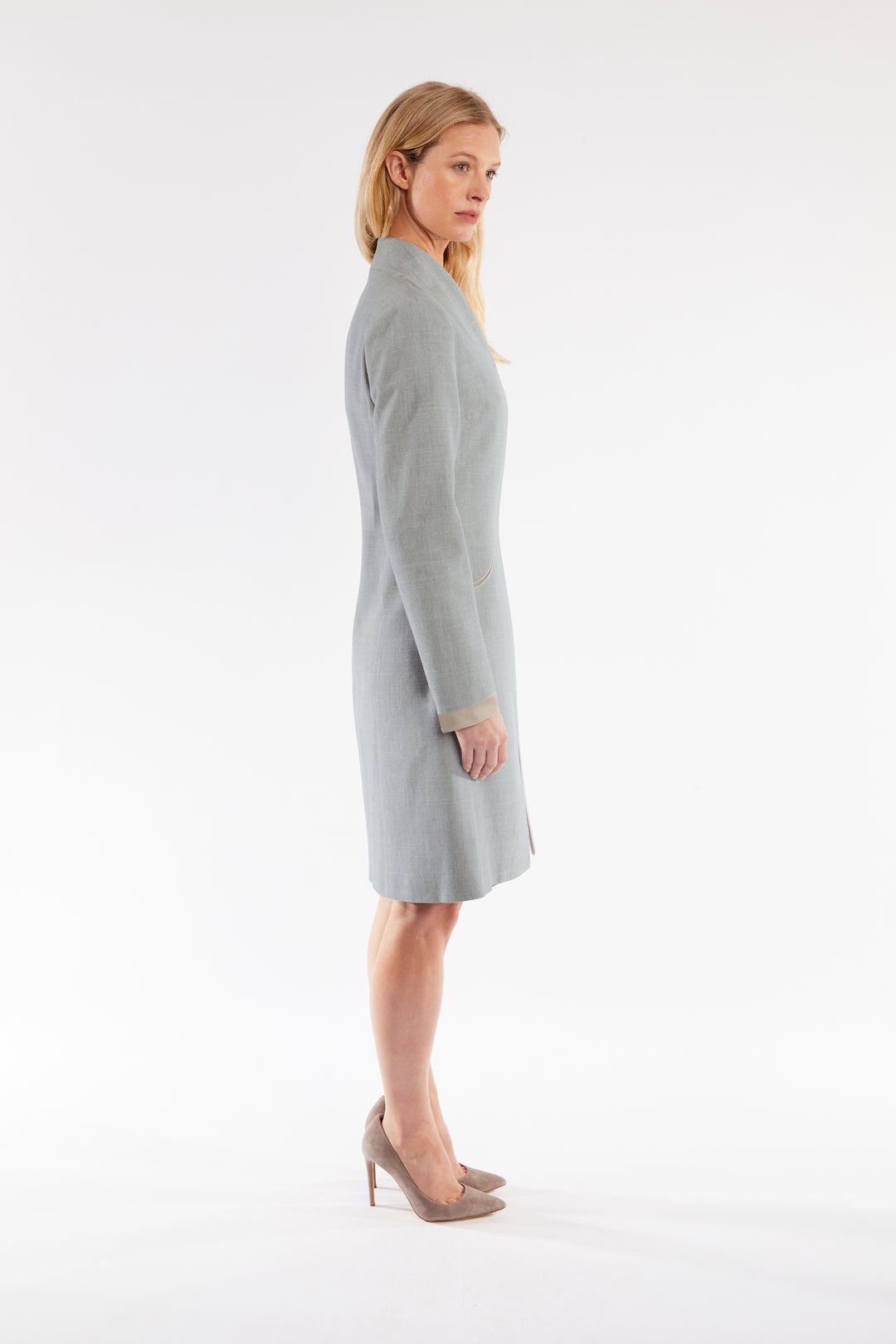 Woman wearing a gray coat on a white background