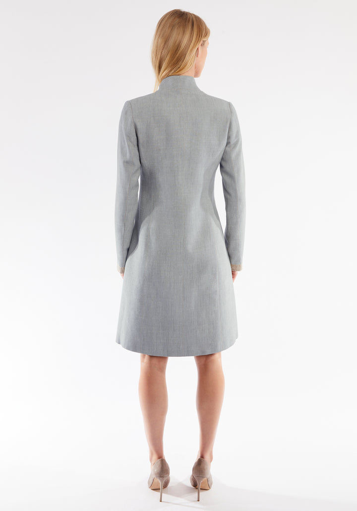 Woman wearing a gray coat on a white background