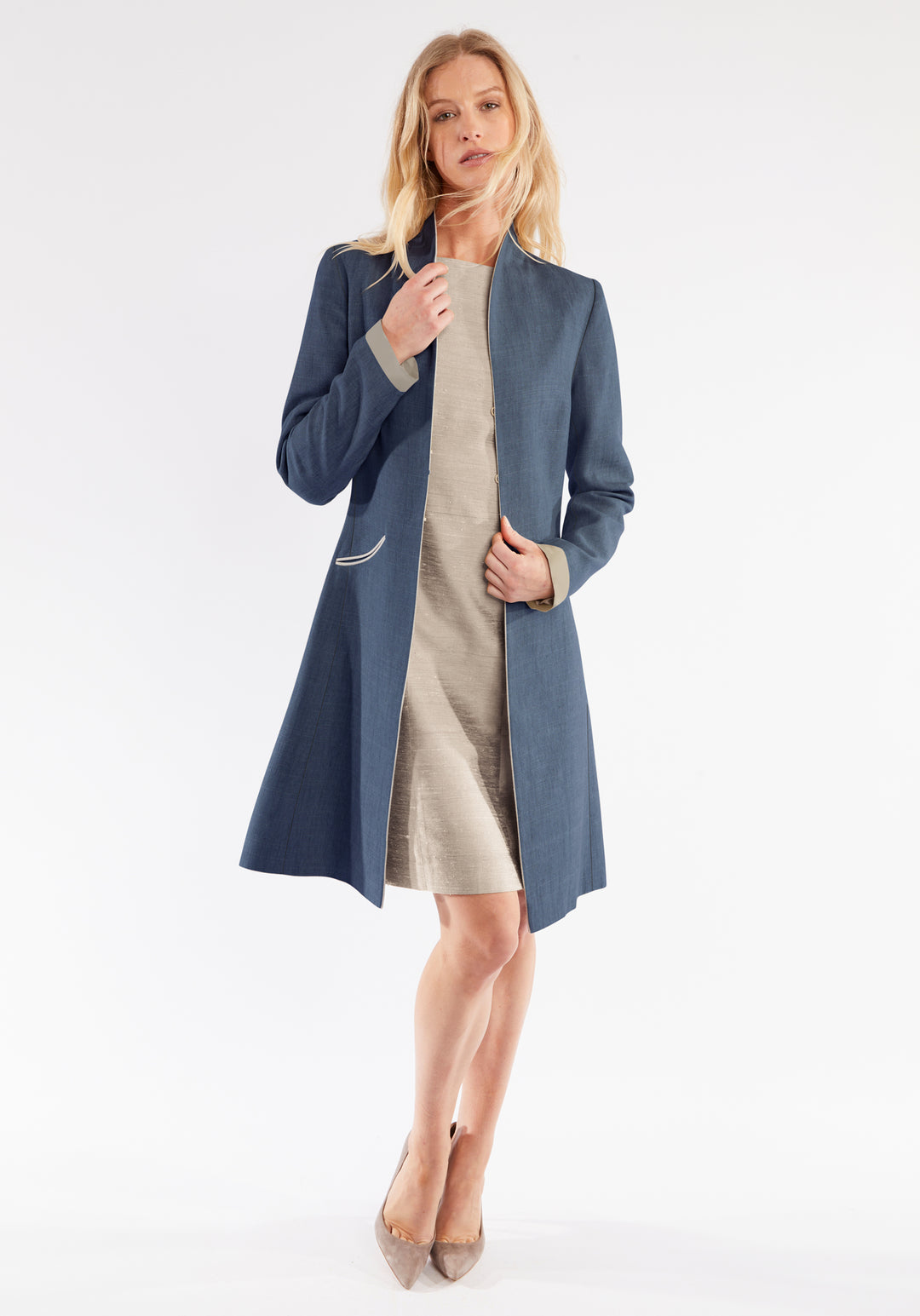 Woman wearing a navy blue coat on a white background