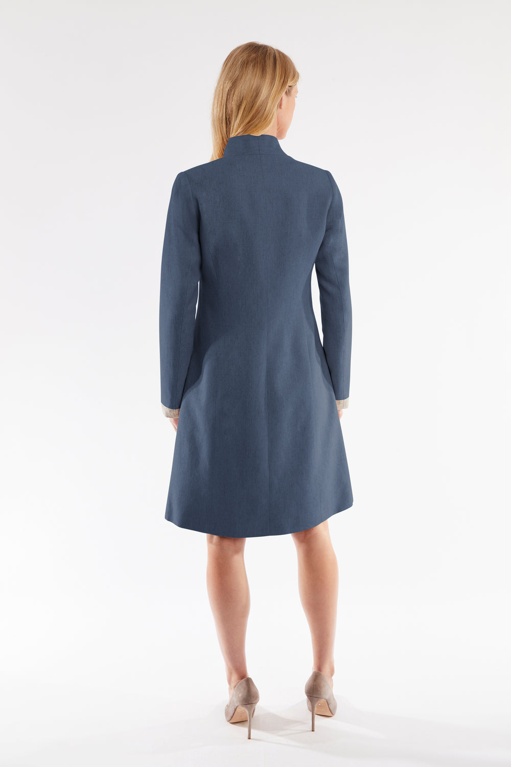Woman wearing a navy blue coat on a white background