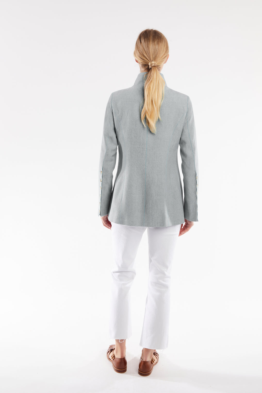 Woman wearing a gray jacket on a white background