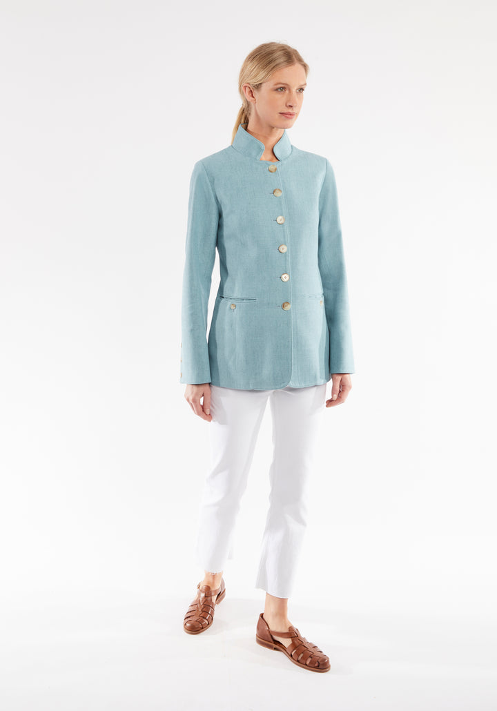 Woman wearing light blue linen jacket with buttons down the front