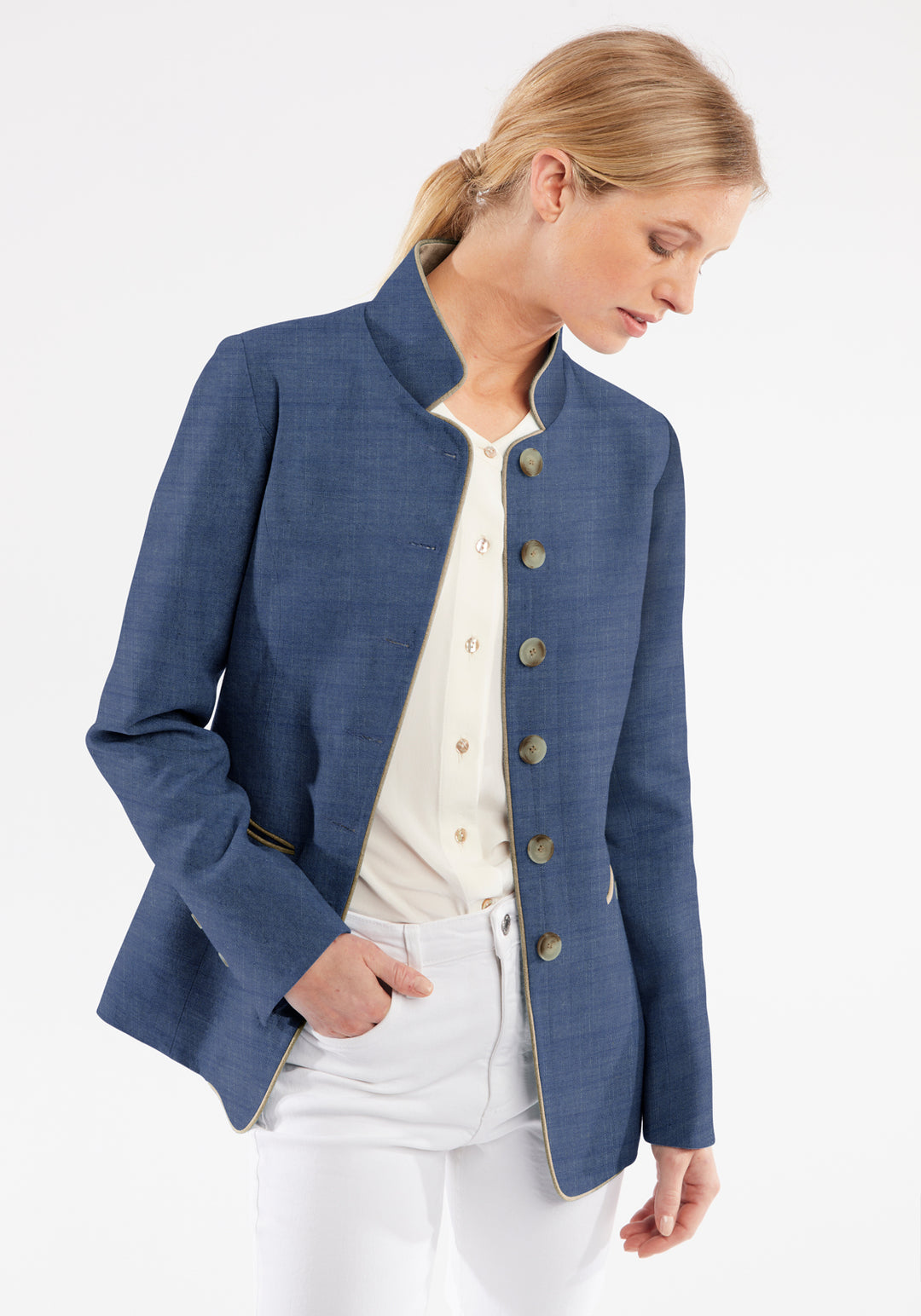 Woman wearing a blue jacket with button details on a white background