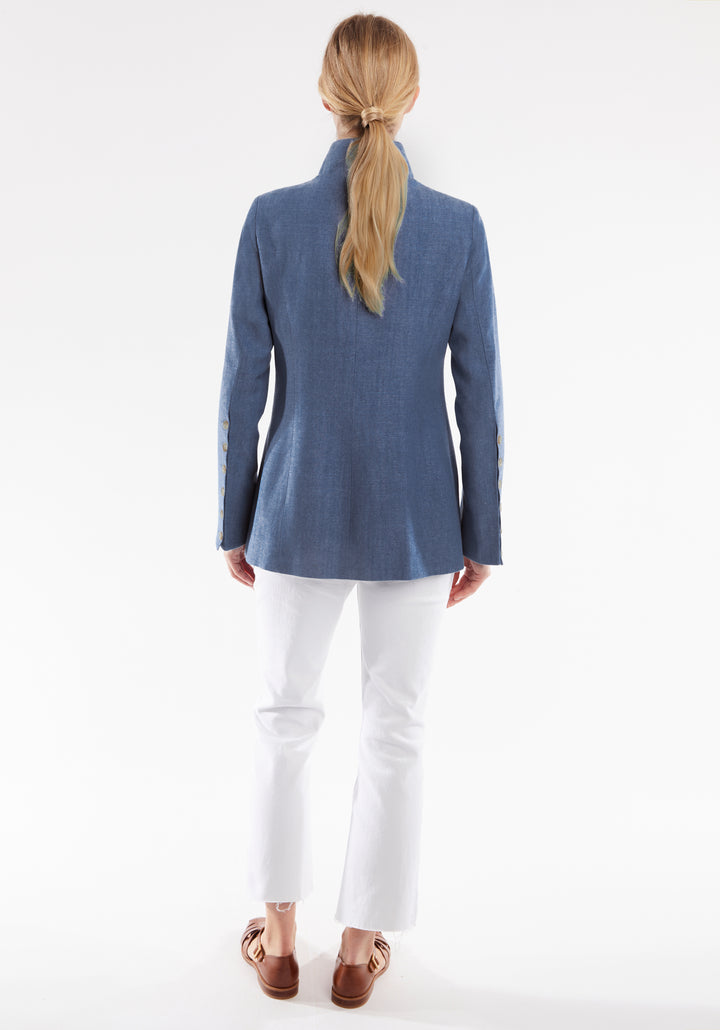 Person wearing a blue jacket and white pants on a white background