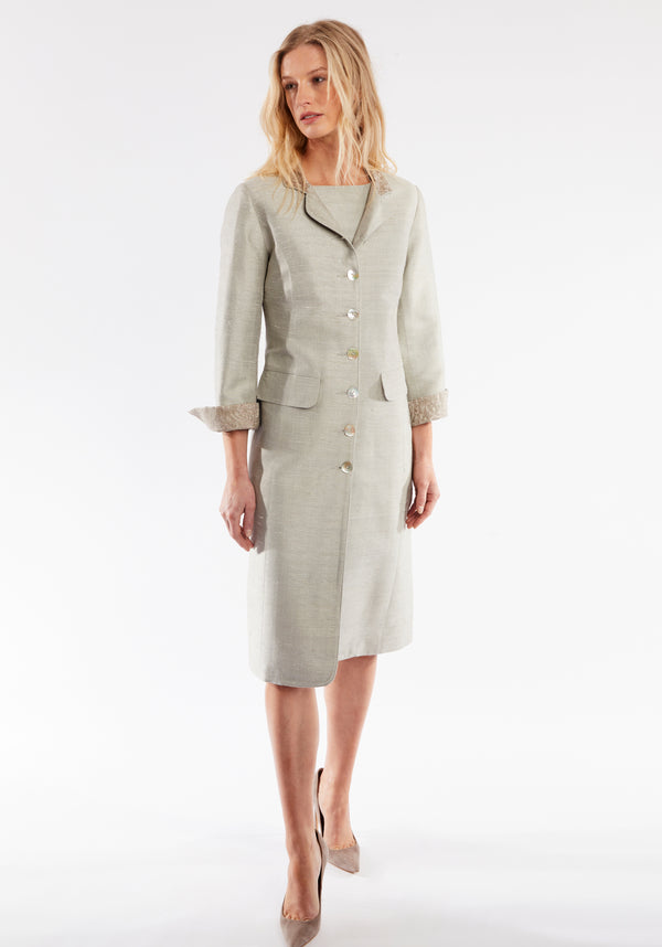 Woman wearing dove grey coat with cuff detailing and mother of pearl buttons
