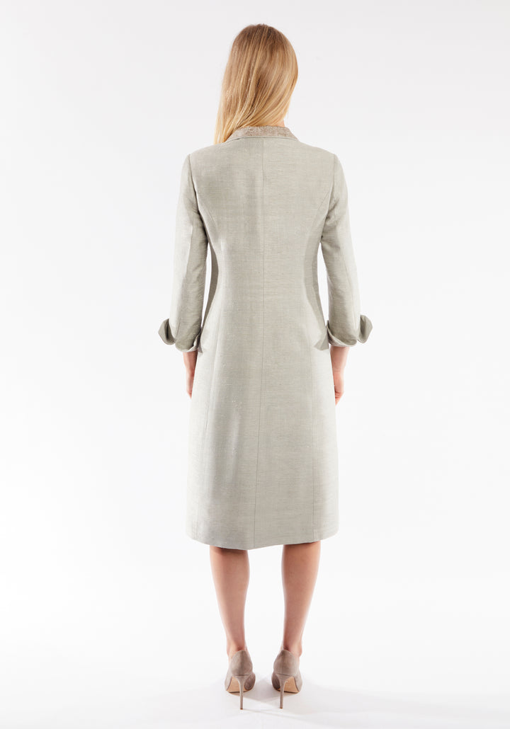 Back of woman wearing dove grey coat with cuff detailing