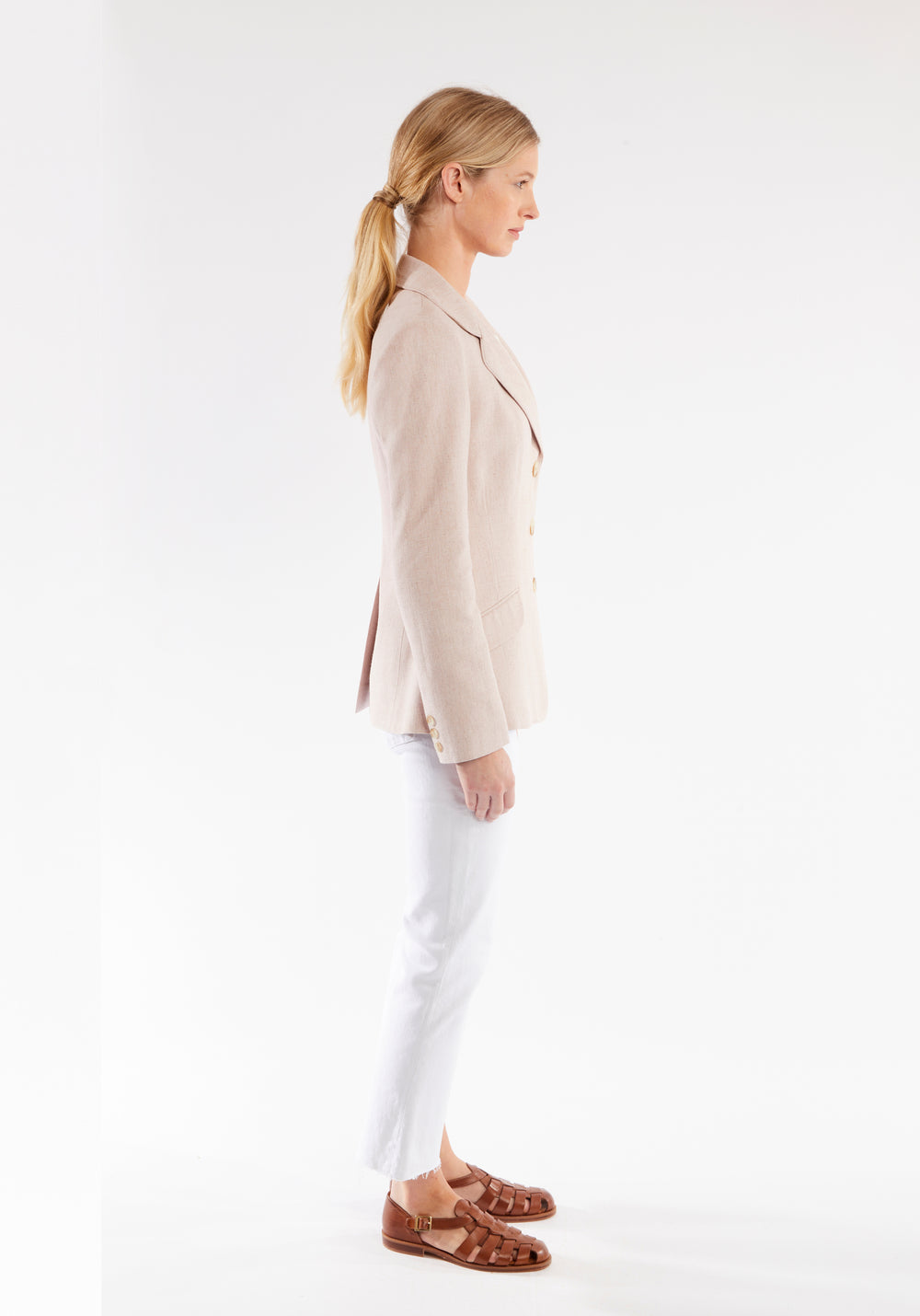 Side of woman wearing light pink jacket
